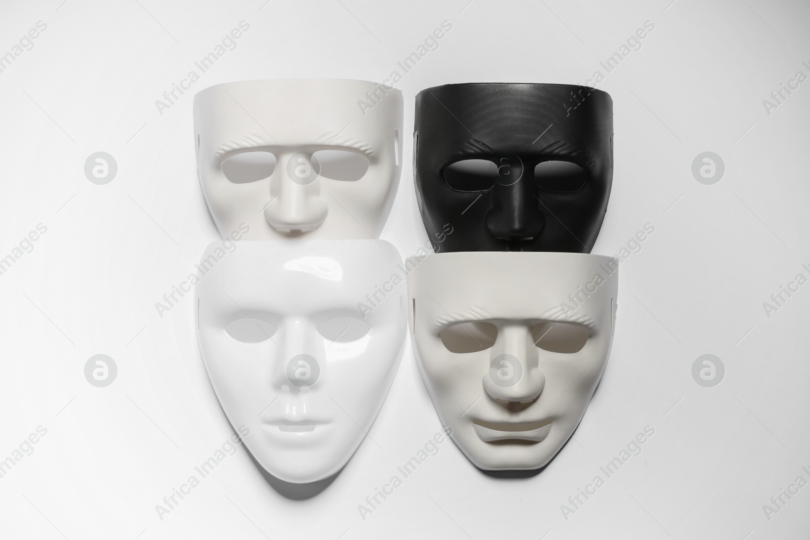 Photo of Theater arts. Many masks on white background, top view