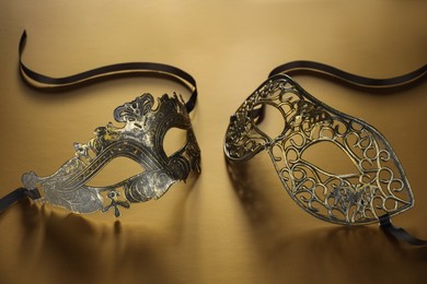 Photo of Elegant face masks on beige background. Theatrical performance