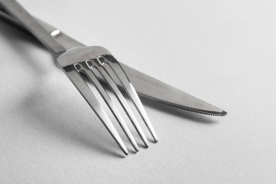 Photo of Stylish silver cutlery on white background, closeup