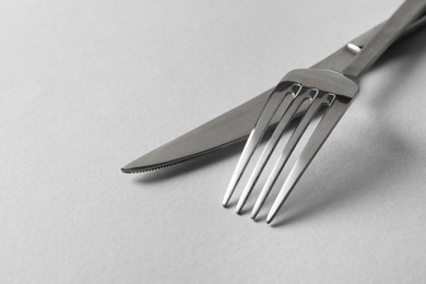 Photo of Stylish silver cutlery on white background, closeup