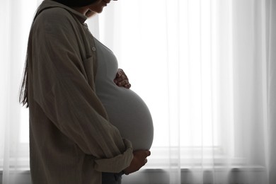 Photo of Beautiful pregnant woman at home, closeup. Space for text