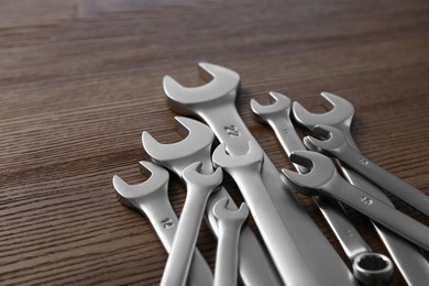 Many auto mechanic's tools on wooden table, closeup