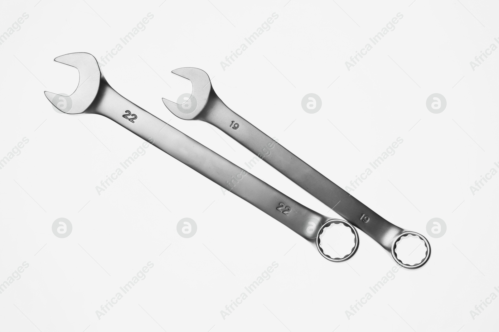 Photo of Two ratcheting wrenches on white background, top view. Auto mechanic tools