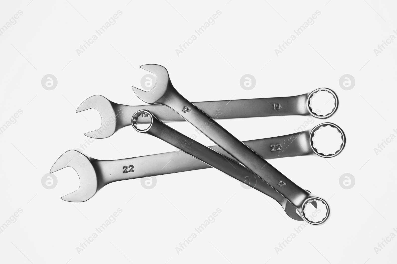 Photo of Set of ratcheting wrenches on white background, top view. Auto mechanic tools