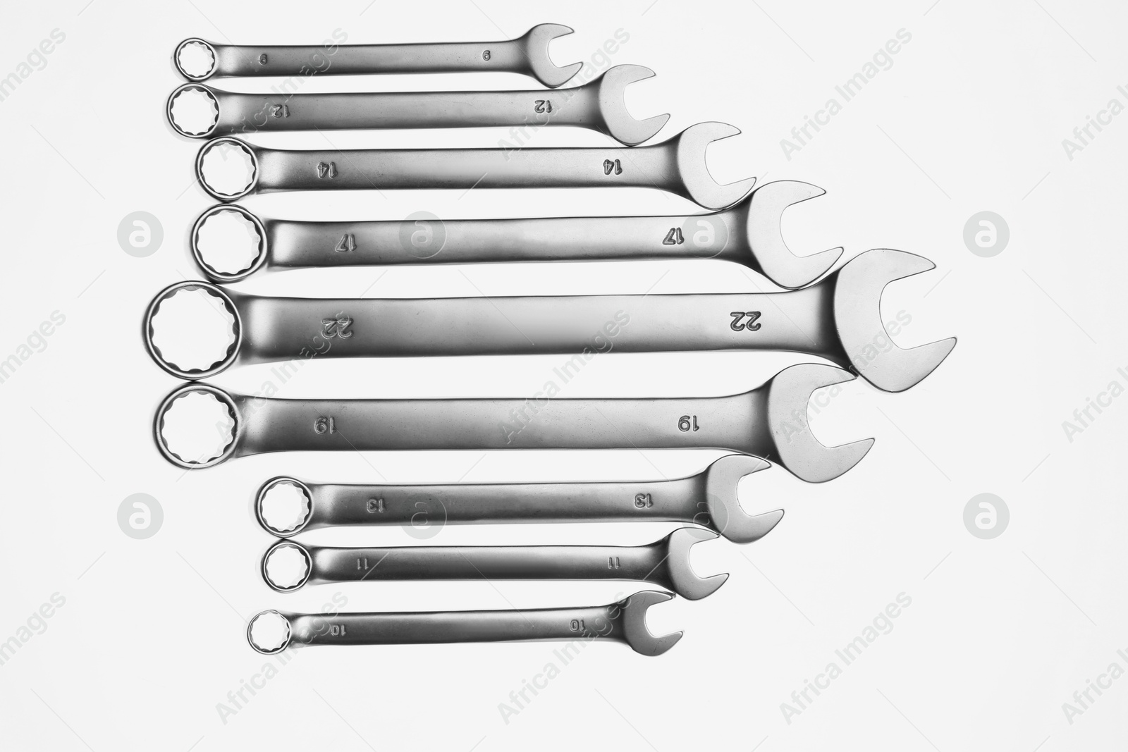 Photo of Set of ratcheting wrenches on white background, top view. Auto mechanic tools