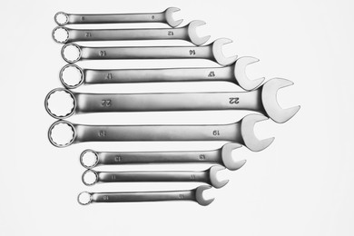 Photo of Set of ratcheting wrenches on white background, top view. Auto mechanic tools