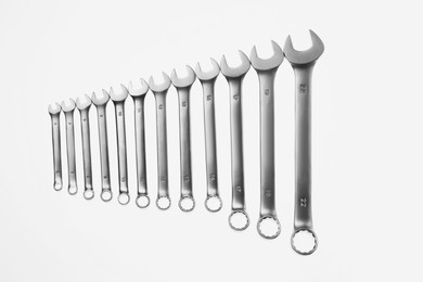 Photo of Set of ratcheting wrenches on white background. Auto mechanic tools