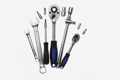 Set of auto mechanic's tools on white background, flat lay