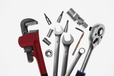 Set of auto mechanic's tools on white background, flat lay