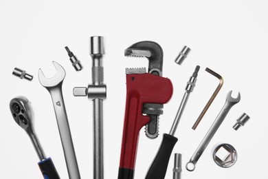 Set of auto mechanic's tools on white background, flat lay