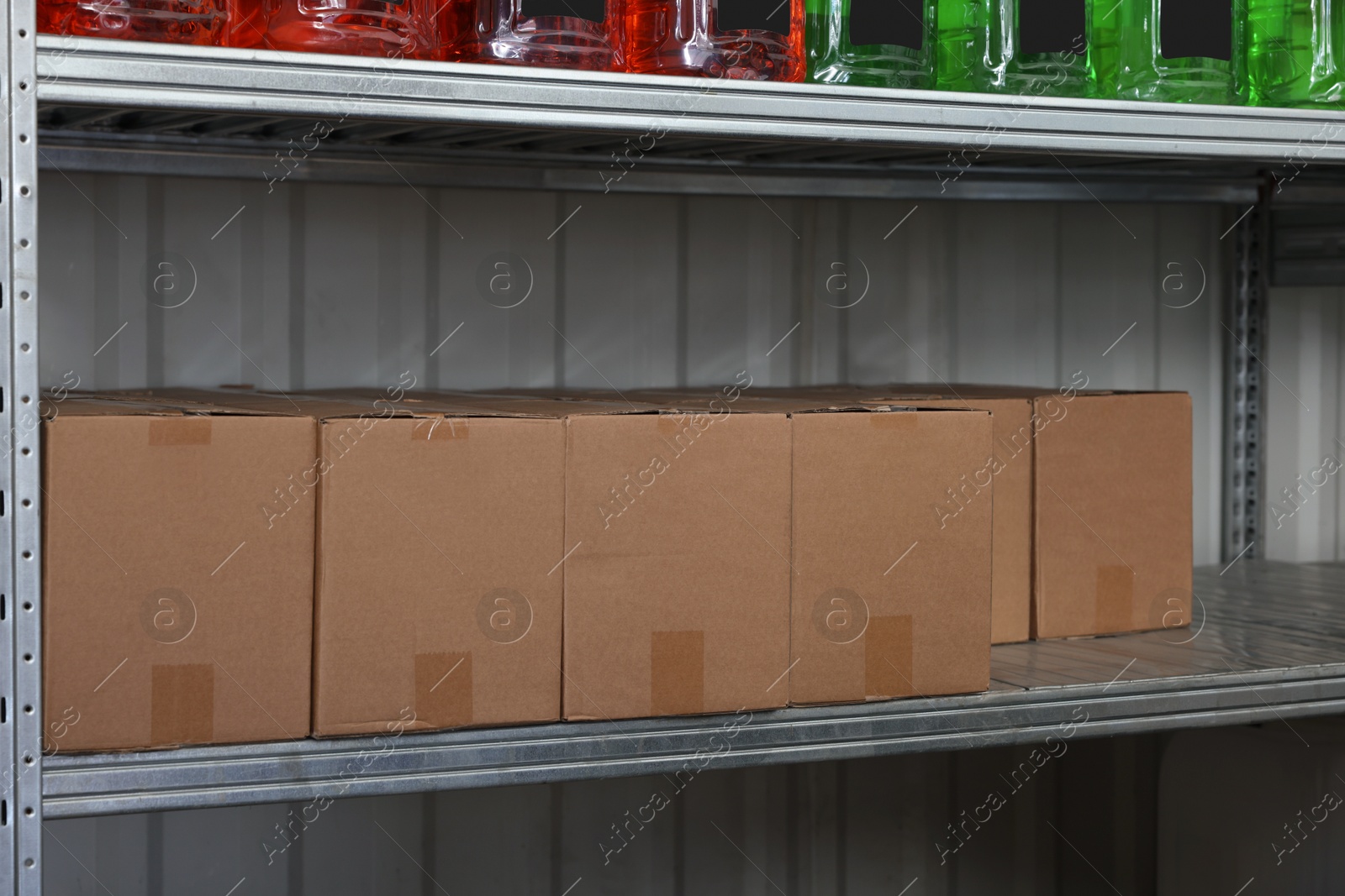 Photo of Cardboard boxes and different car cleaning products in auto store