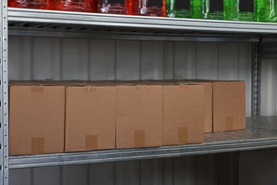 Cardboard boxes and different car cleaning products in auto store