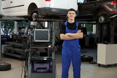 Young auto mechanic at automobile repair shop