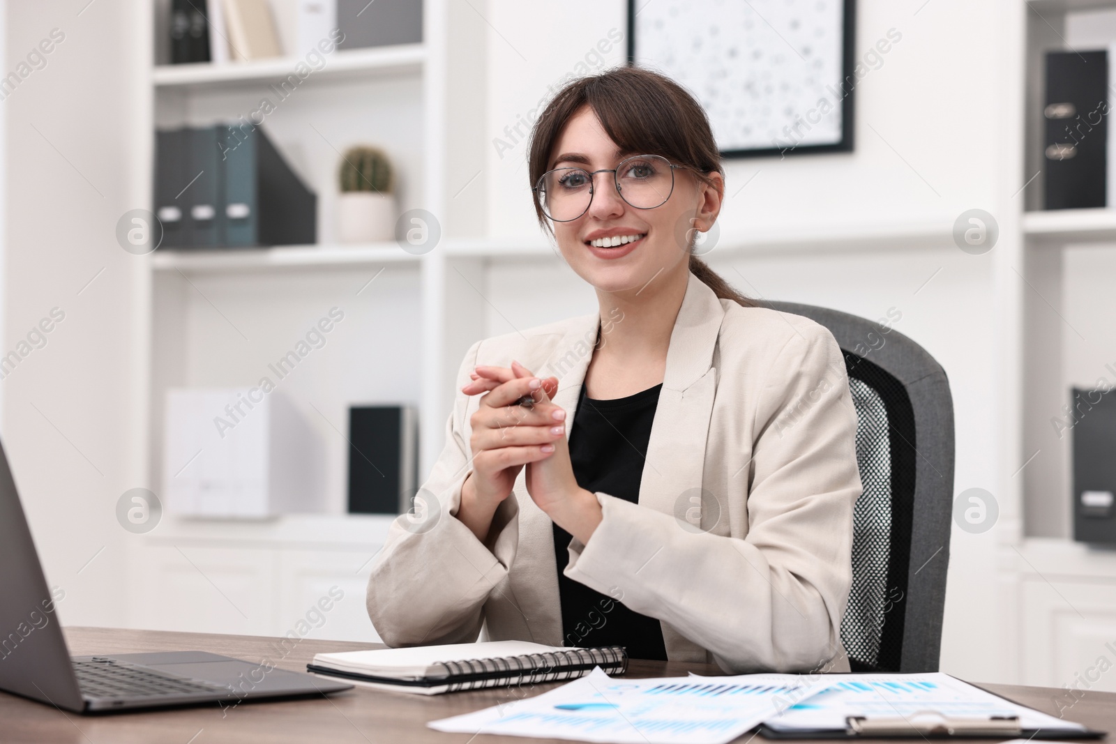 Photo of Portrait of smiling business consultant at table in office