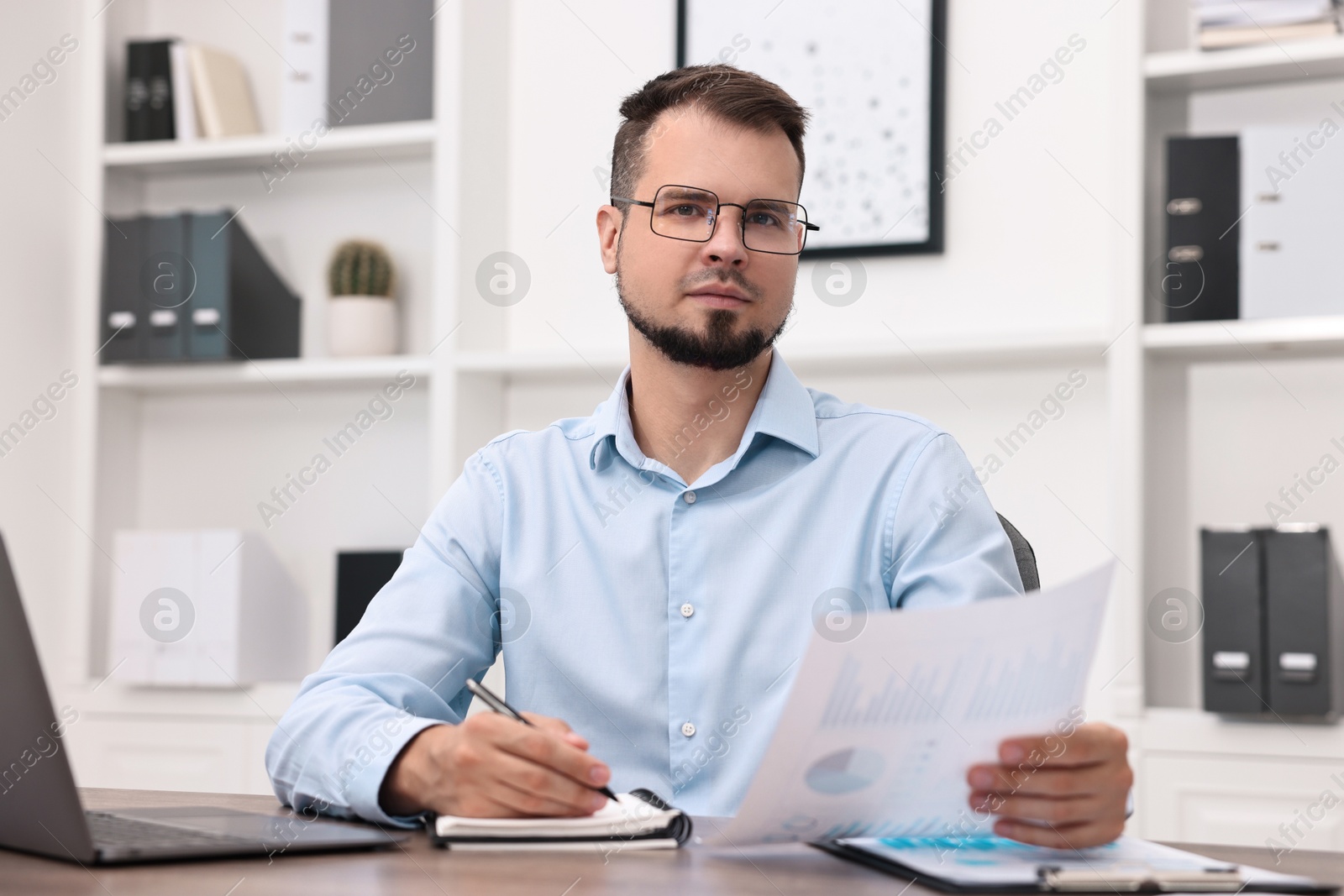 Photo of Portrait of business consultant at table in office