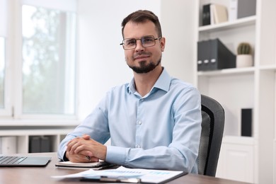 Photo of Portrait of business consultant at table in office