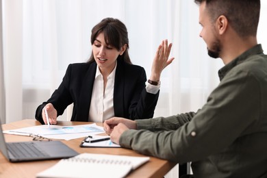 Consultant working with partner at table in office. Business meeting