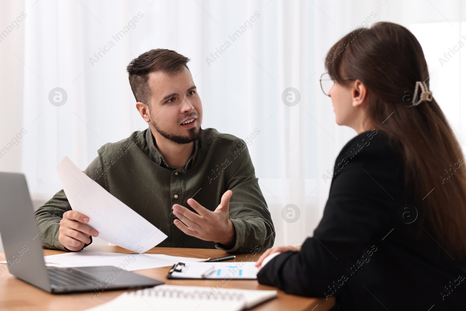 Photo of Consultant working with partner at table in office. Business meeting