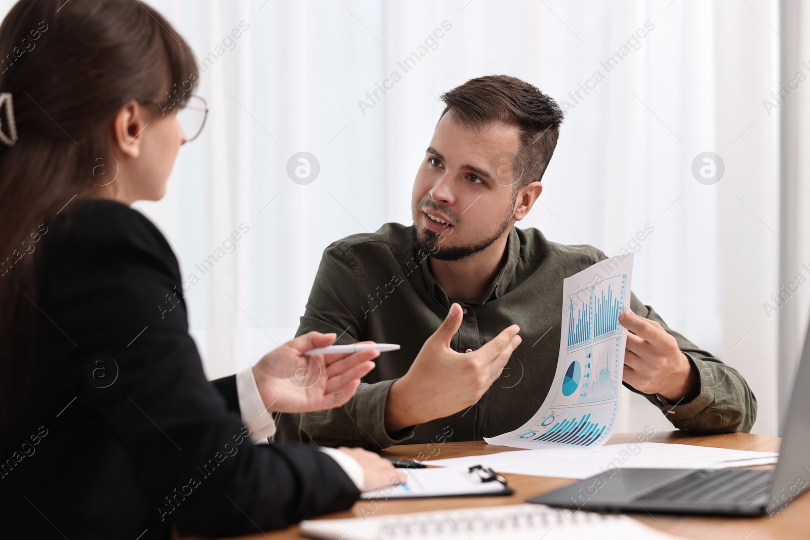 Photo of Consultant working with partner at table in office. Business meeting