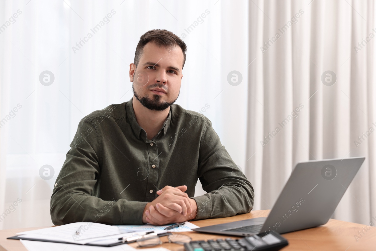 Photo of Portrait of business consultant at table in office