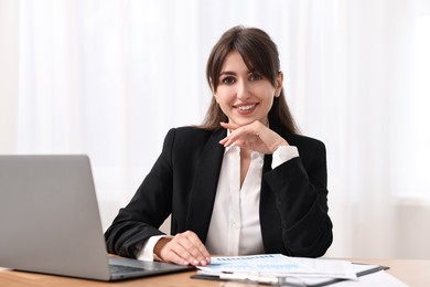 Portrait of smiling business consultant at table in office