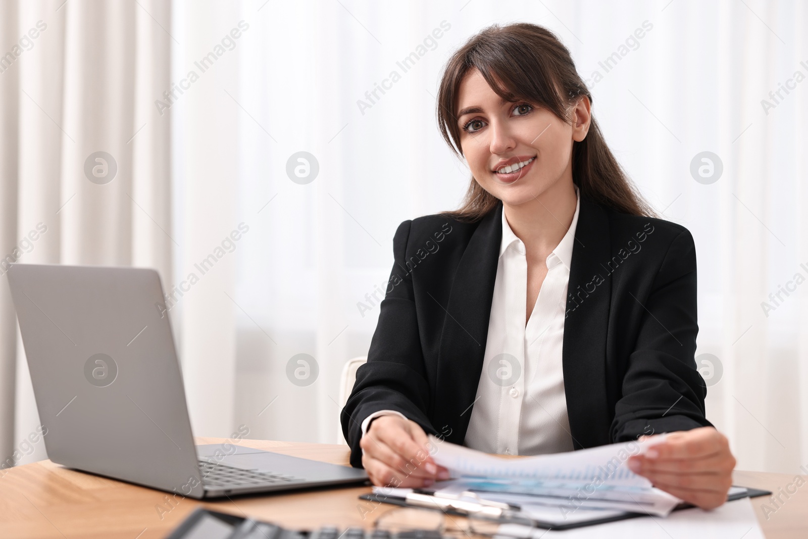 Photo of Portrait of smiling business consultant at table in office