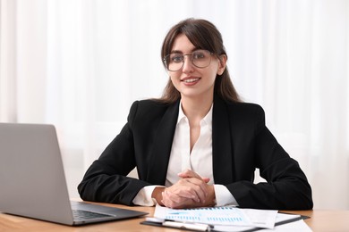 Portrait of smiling business consultant at table in office