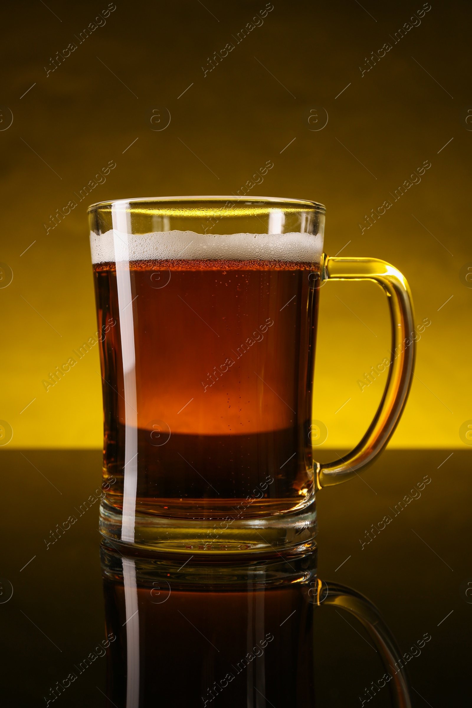 Photo of Glass of beer with froth on dark table, closeup