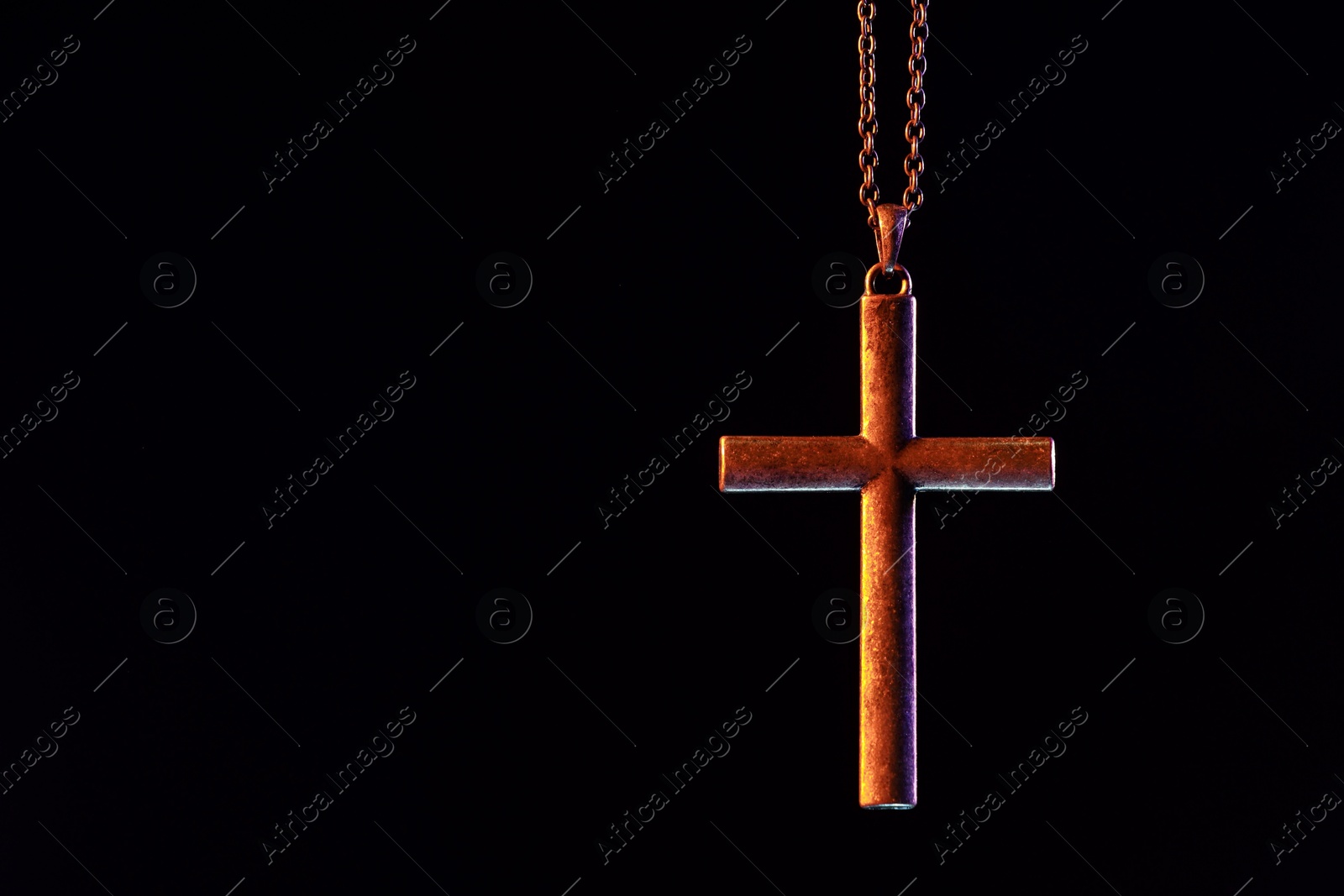 Photo of One cross with chain on black background, space for text. Religion of Christianity