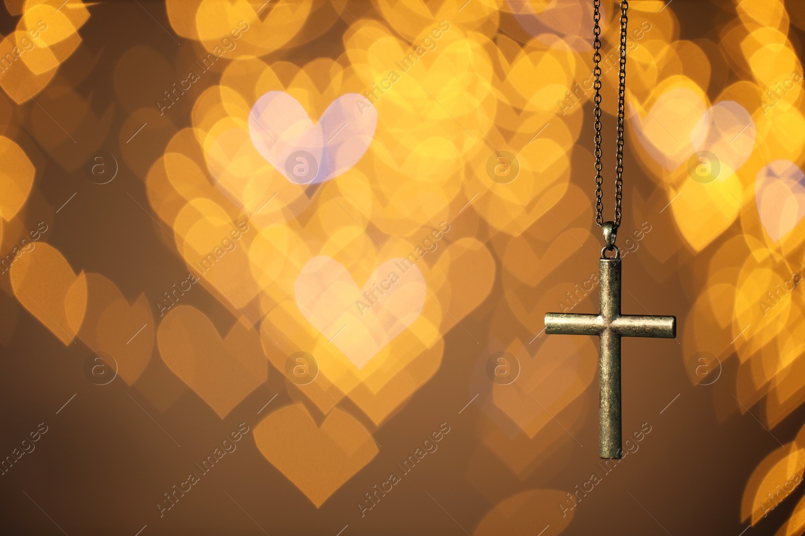 Photo of Wooden cross against blurred lights, closeup with space for text. Religion of Christianity