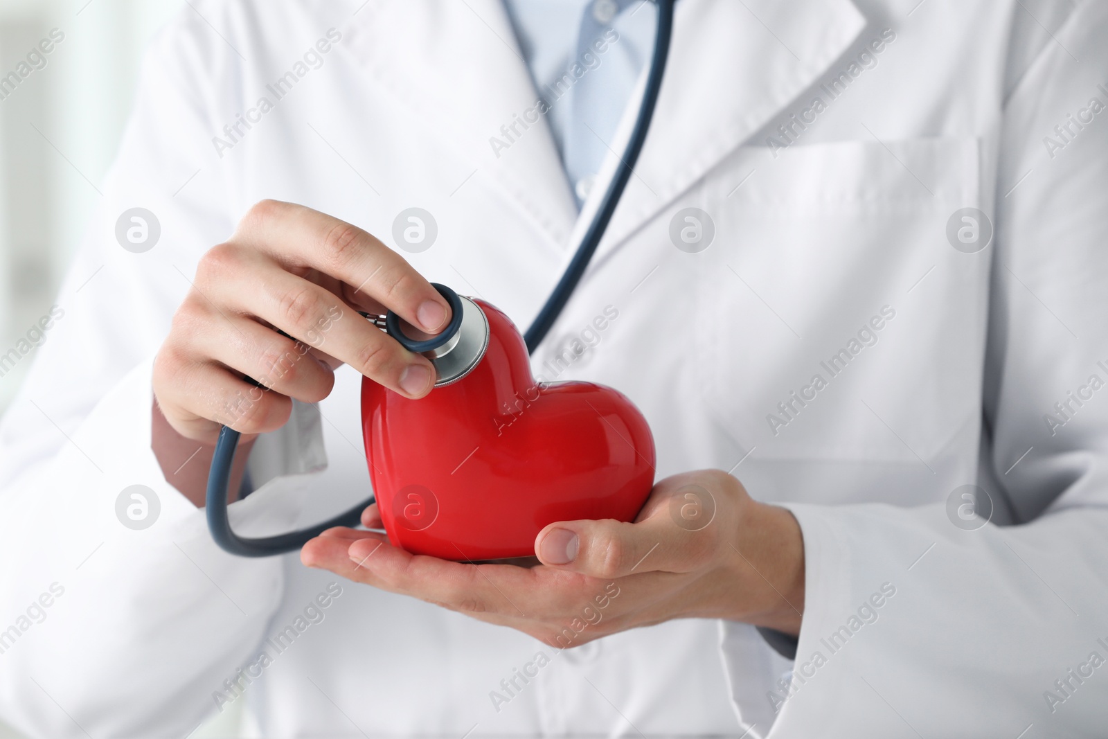 Photo of Doctor with stethoscope and red heart, closeup