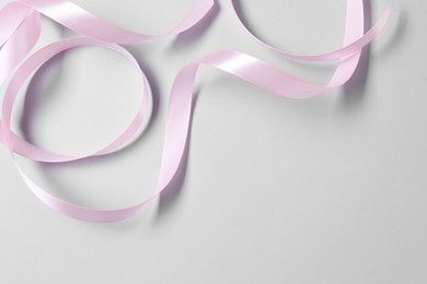 Photo of One beautiful pink ribbon on white background