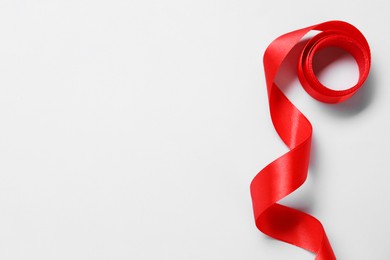 One beautiful red ribbon on white background