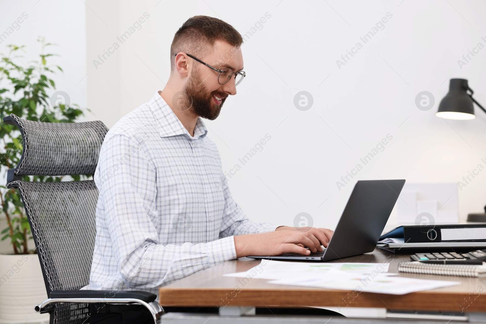 Photo of Man with good posture working in office