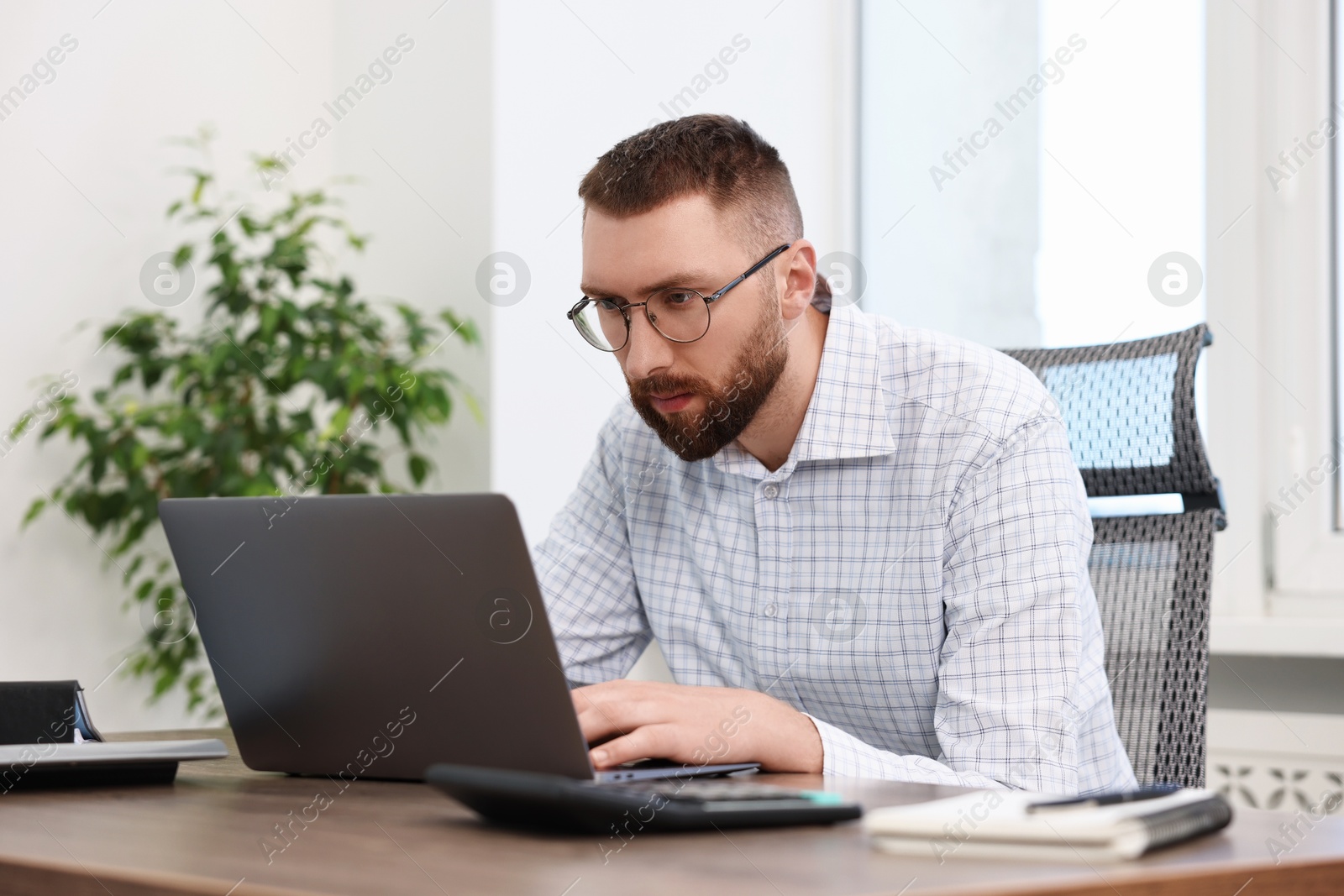 Photo of Man with poor posture working in office