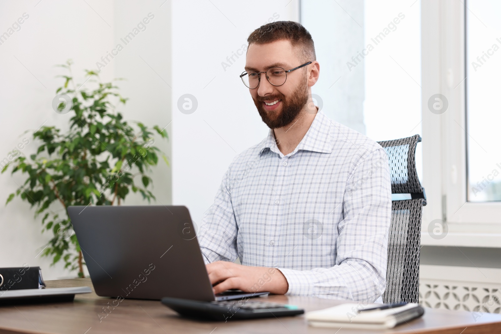 Photo of Man with good posture working in office