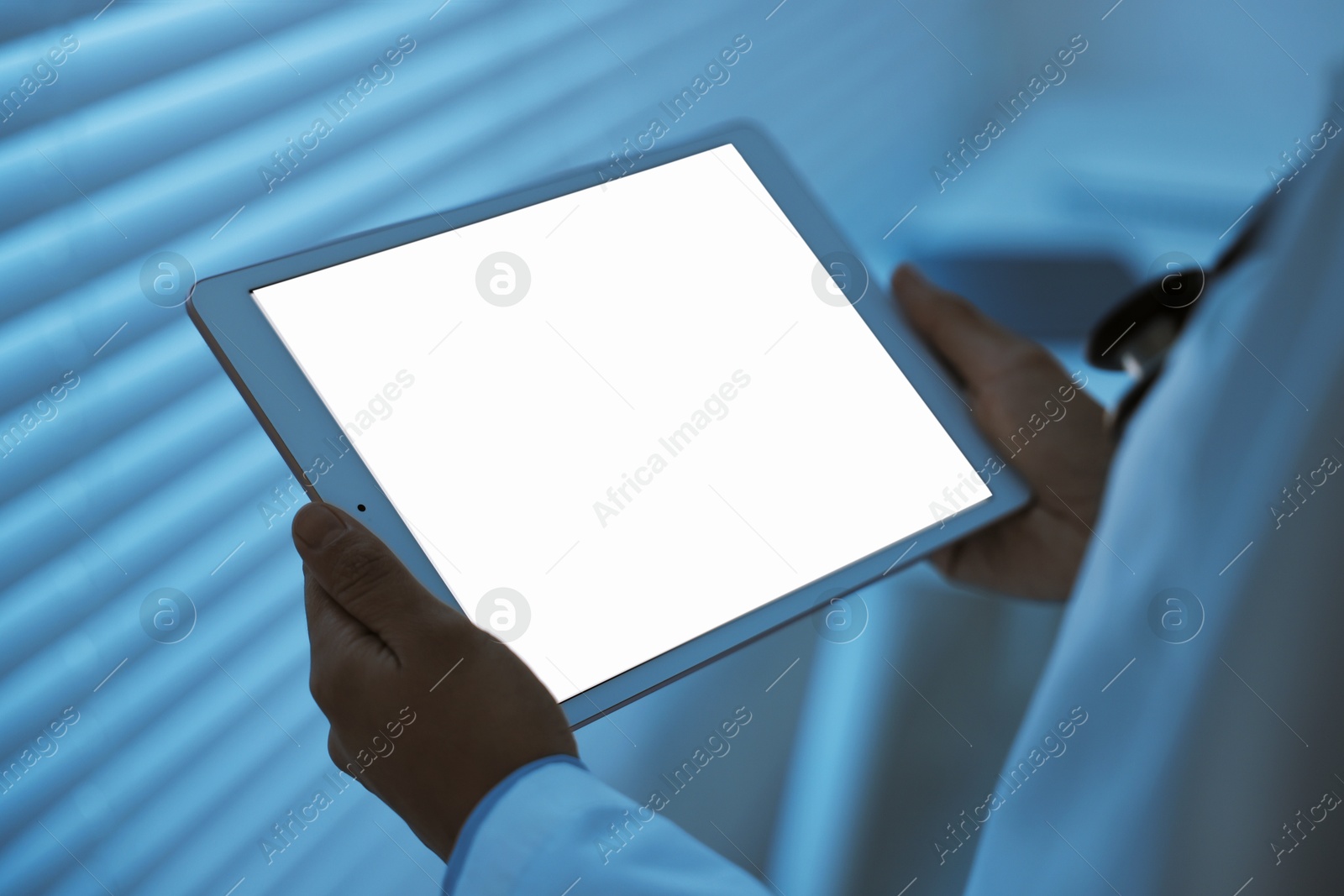 Photo of Doctor using tablet in hospital at night, closeup