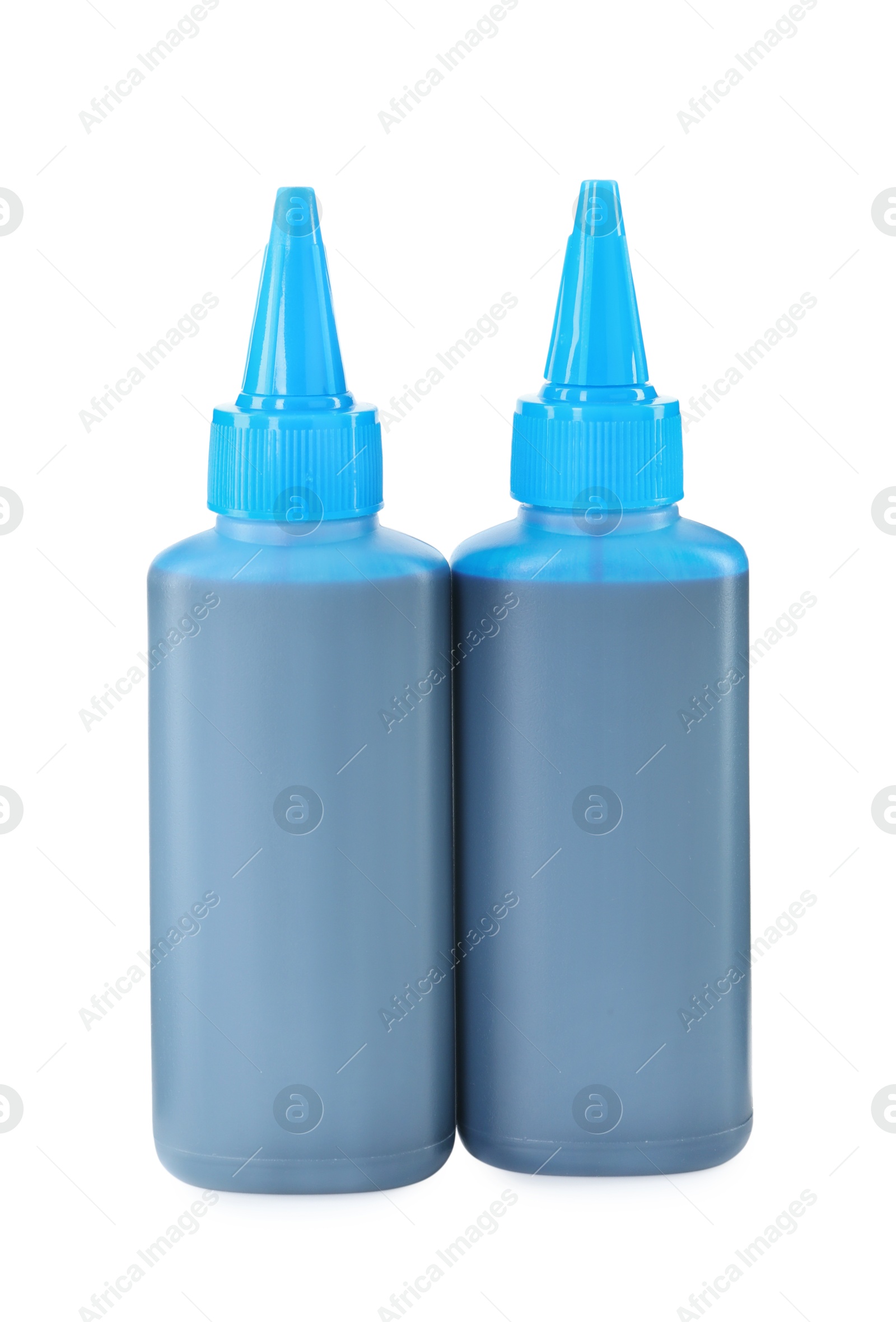 Photo of Bottles of light blue printer ink isolated on white