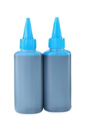 Photo of Bottles of light blue printer ink isolated on white