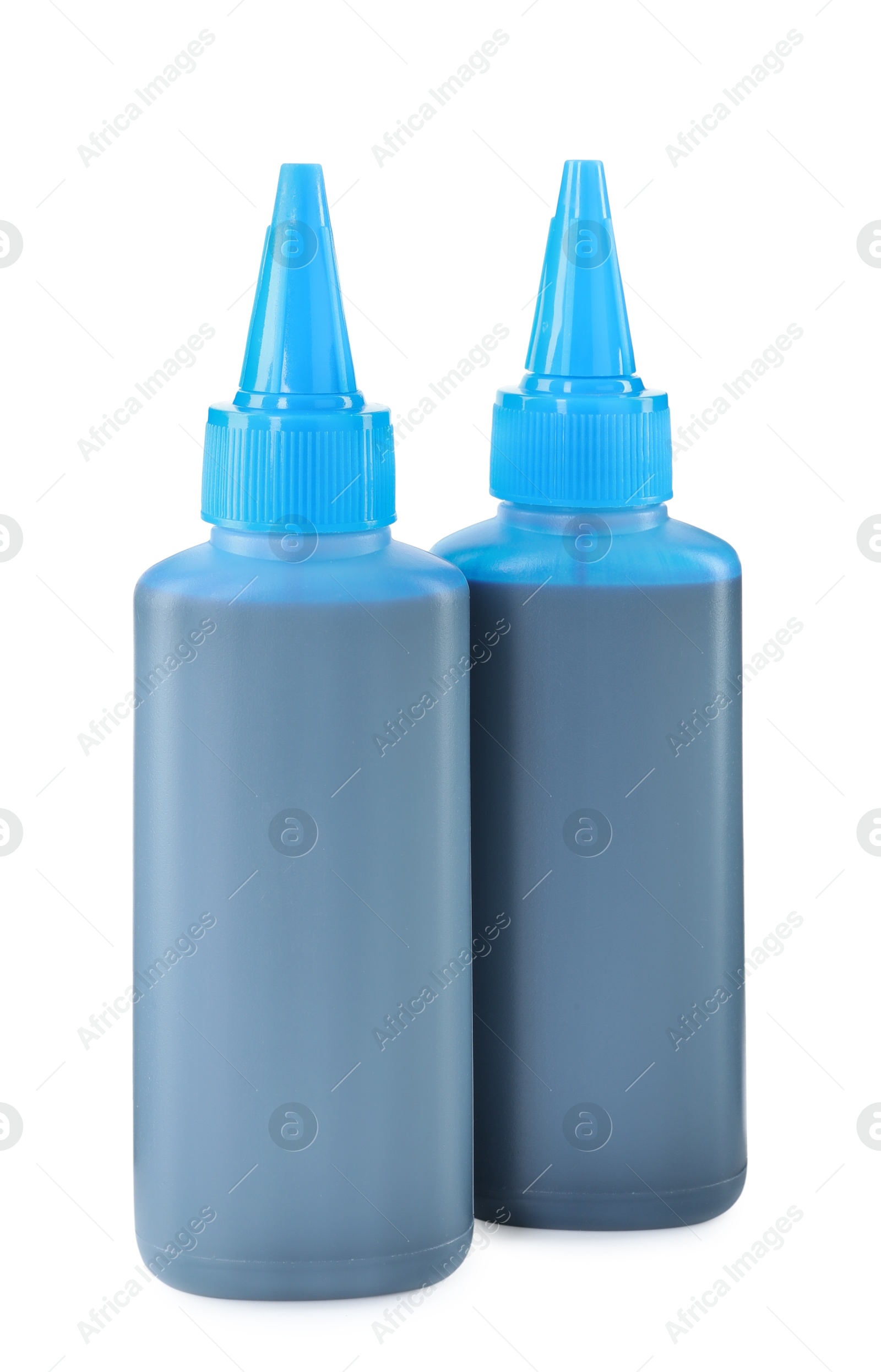 Photo of Bottles of light blue printer ink isolated on white