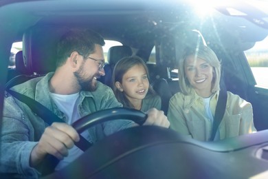 Happy family enjoying trip together by car, view through windshield