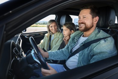 Happy family enjoying trip together by car, view from outside