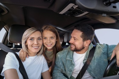 Happy family enjoying trip together by car, view from inside