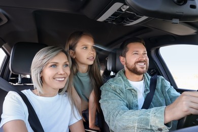 Photo of Happy family enjoying trip together by car, view from inside