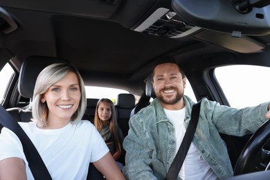 Happy family enjoying trip together by car, view from inside