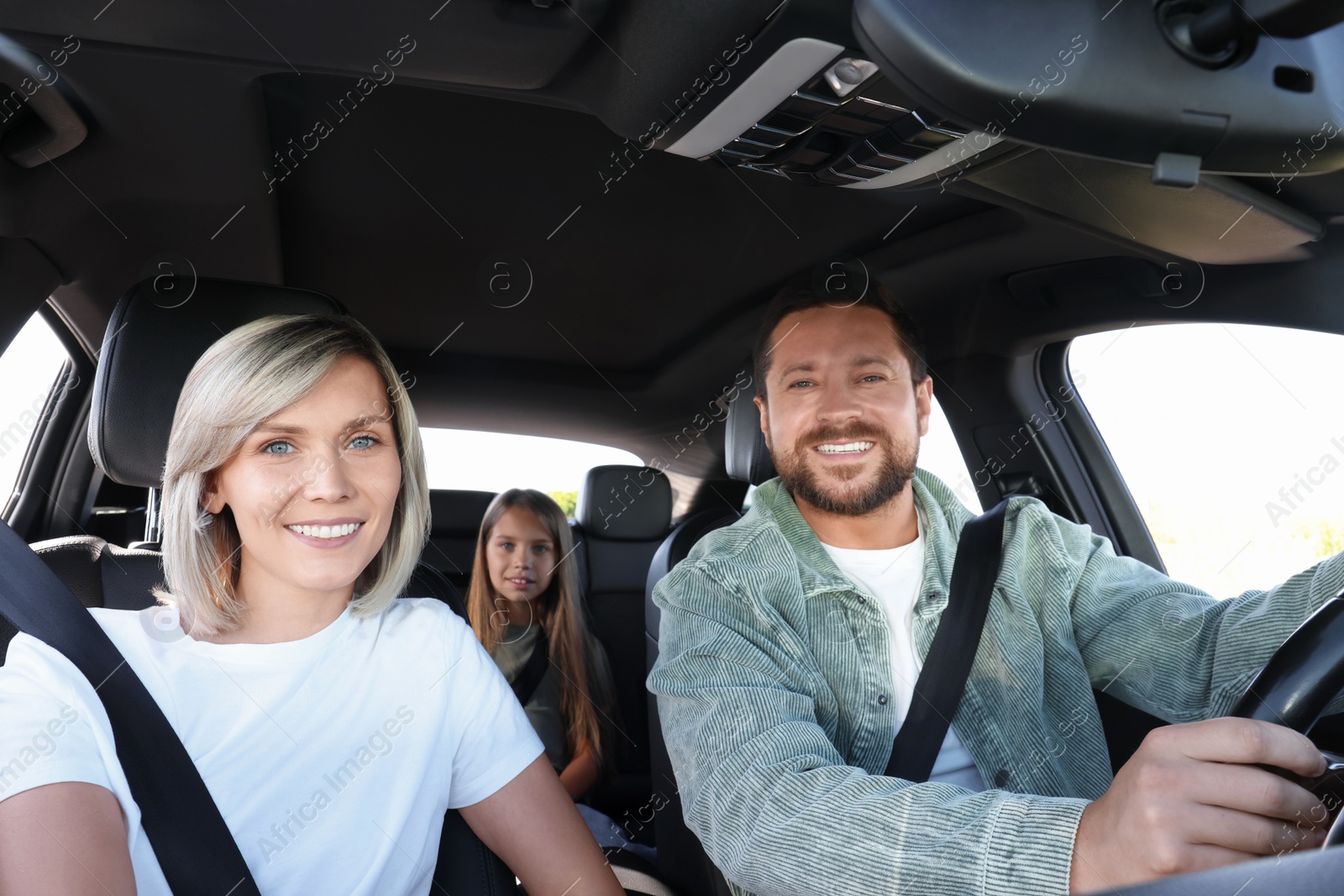 Photo of Happy family enjoying trip together by car, view from inside