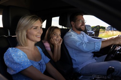 Happy family enjoying trip together by car, view from outside