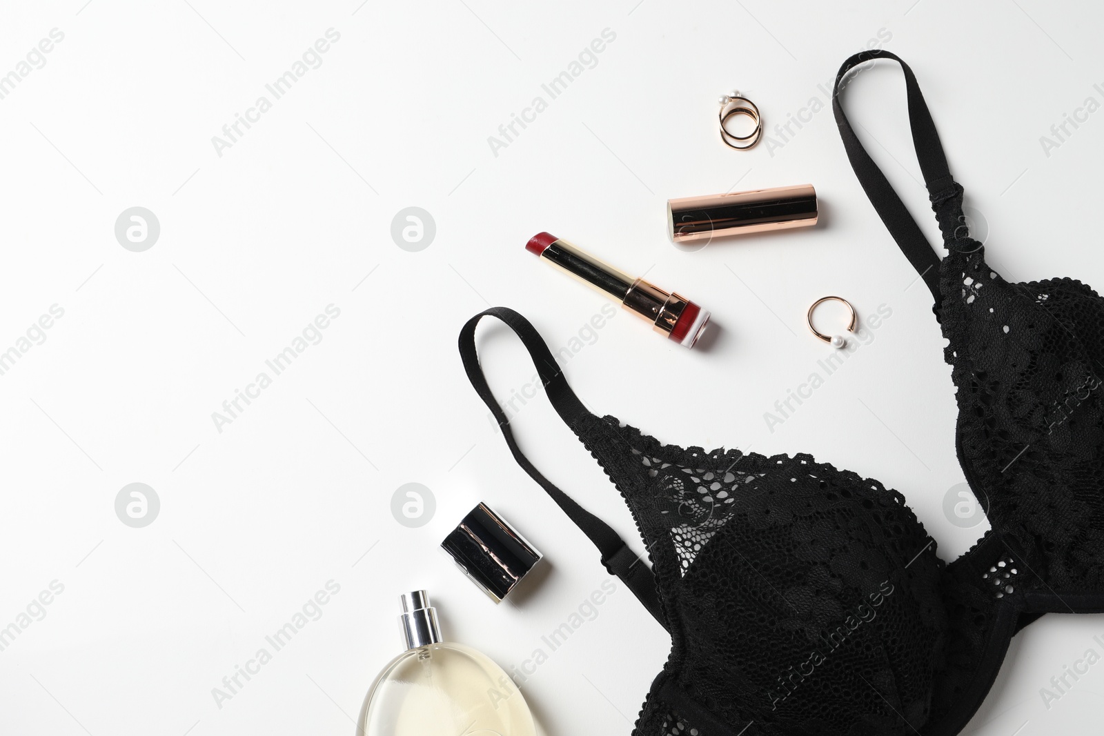 Photo of Beautiful lace bra and accessories on white background, flat lay. Space for text