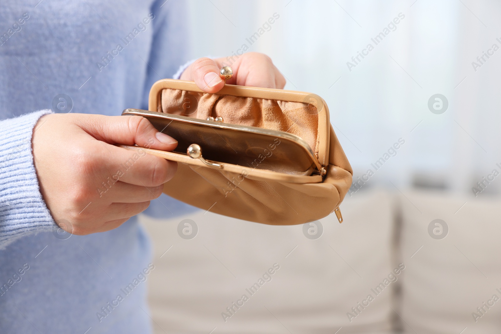 Photo of Woman with empty wallet indoors, closeup view