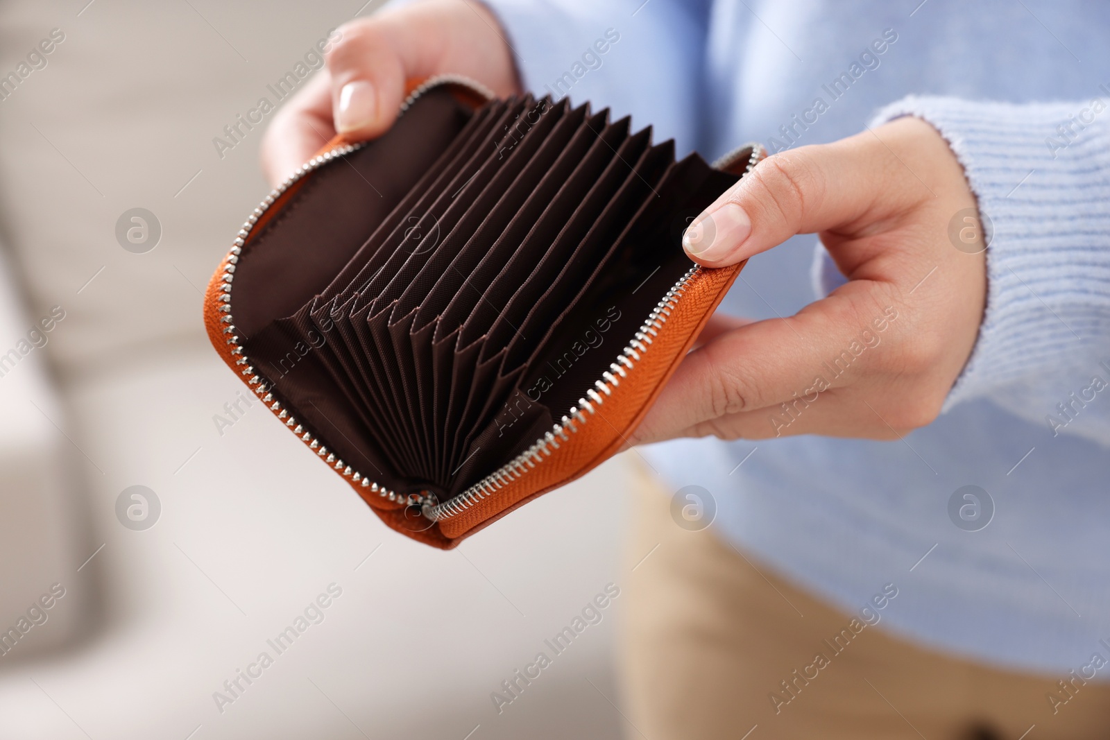 Photo of Woman with empty wallet indoors, closeup view